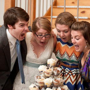 Bride and Groom with friend make funny faces at Cupcake Tower
