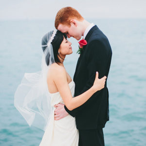 Bride and Groom Embrace in Front of Lake Michigan in Chicago