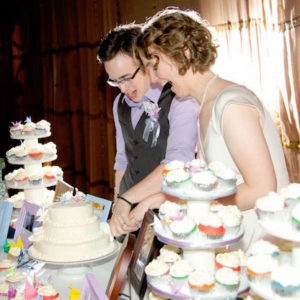 Newlyweds Cut Rainbow Cake and Cupcakes at Wedding