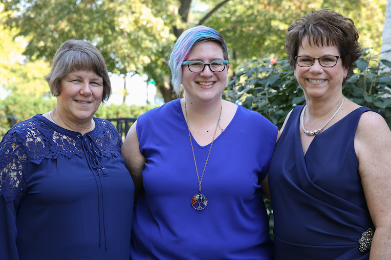 Pam, left, Cindy Savage, wedding planner at Aisle Less Traveled, and Mary, right, stand together outside at the Stone Porch B&B after their wedding ceremony.