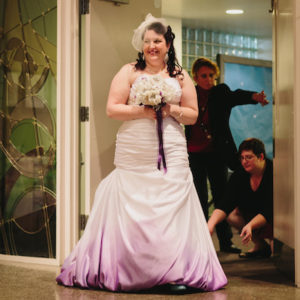 Wedding Planner Adjusts Bride's Purple Ombre Wedding Gown Train