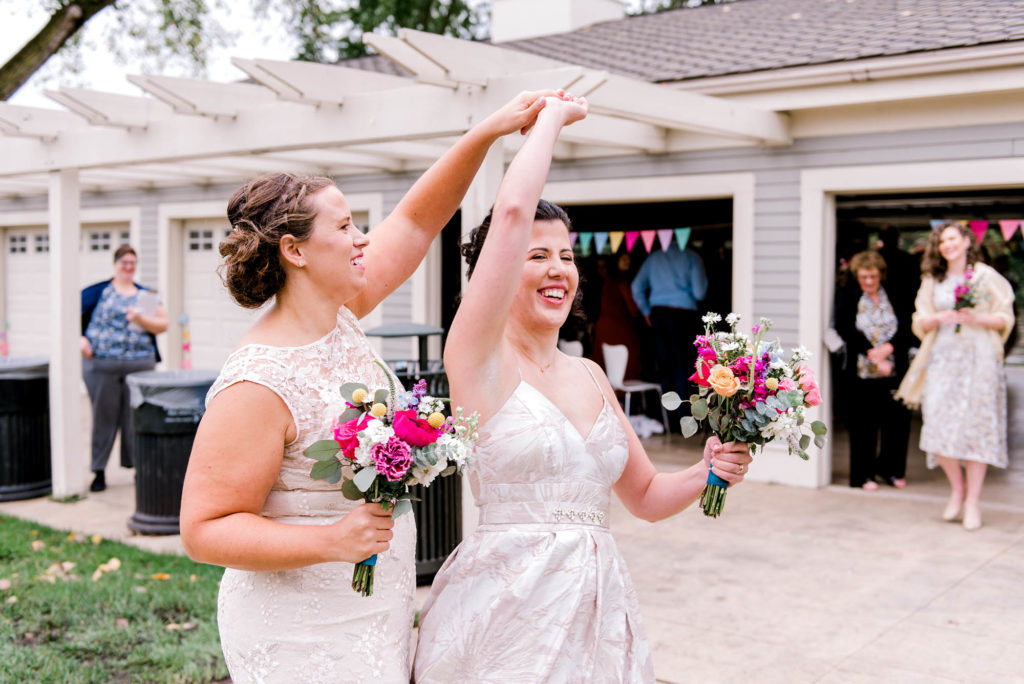 Bride twirls her new wife after wedding ceremony