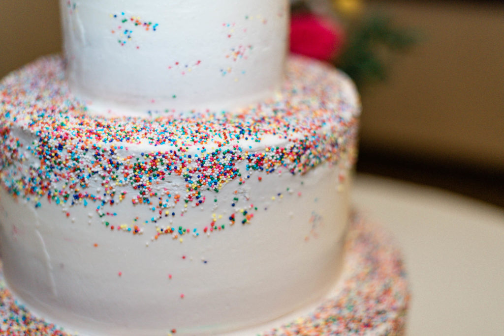 Rainbow sprinkles on 3-tier wedding cake