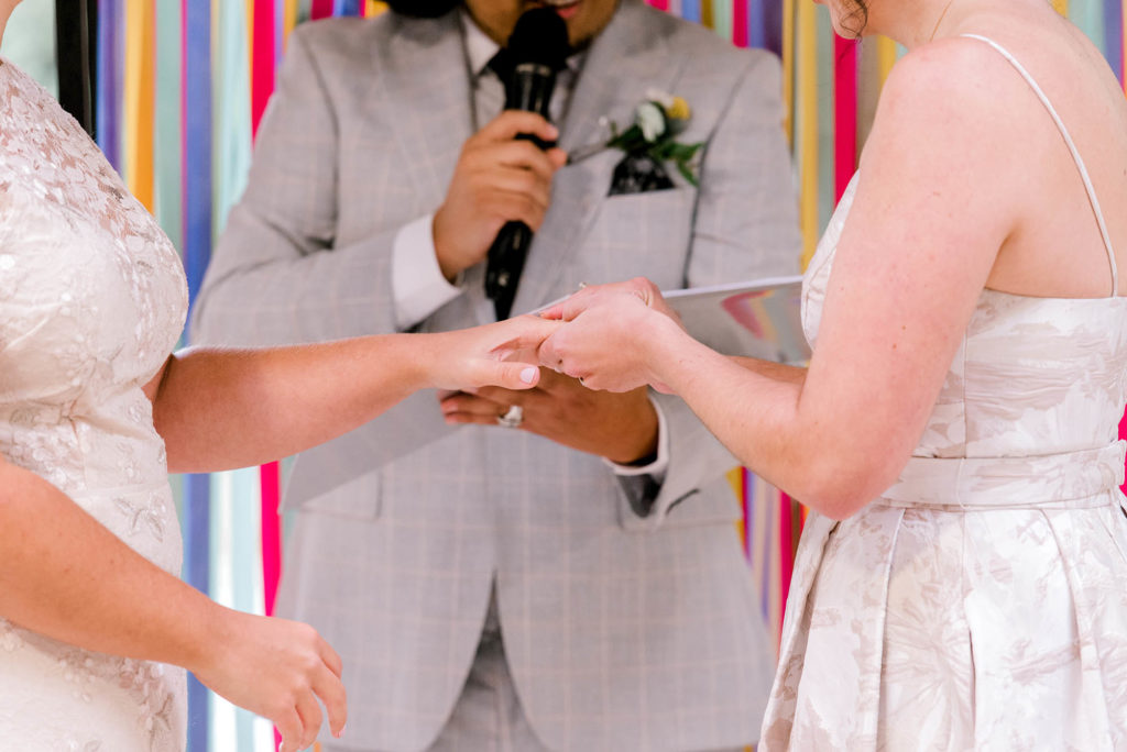 Two brides exchange wedding rings