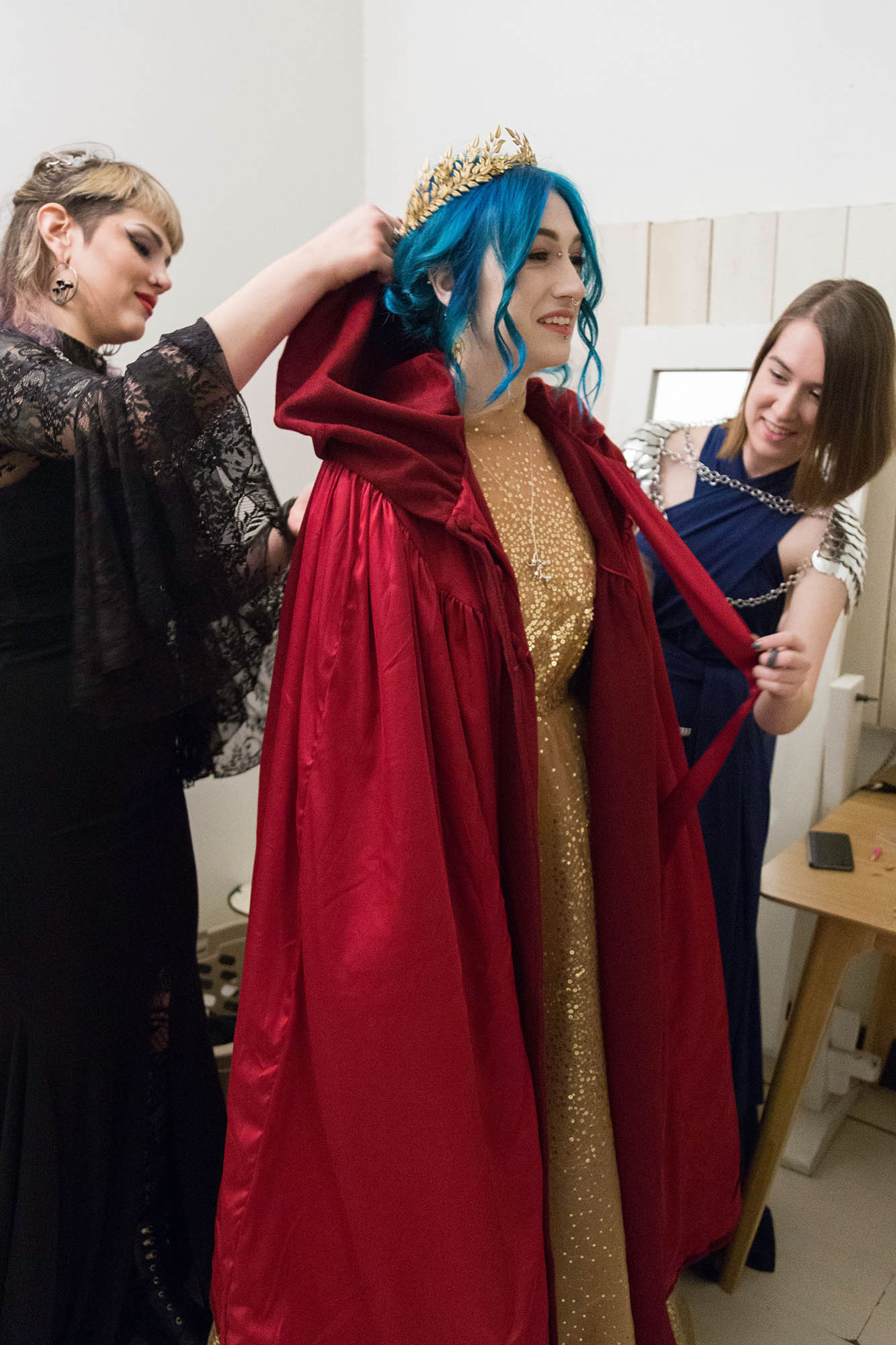 Bridesmaids help Bride put on Red Wedding Cape and Crown