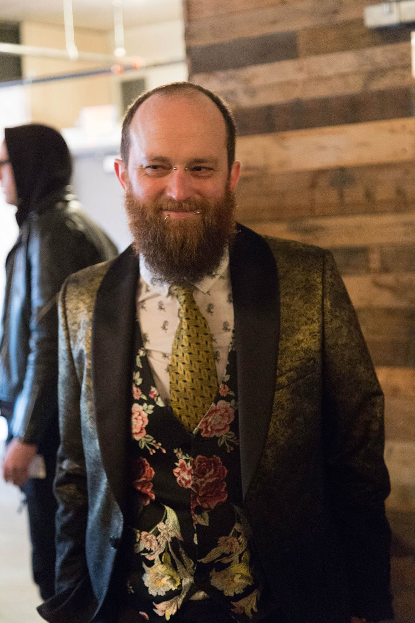 Groom with Beard and Facial Piercings Wearing Gold Floral Vest and Suit Jacket