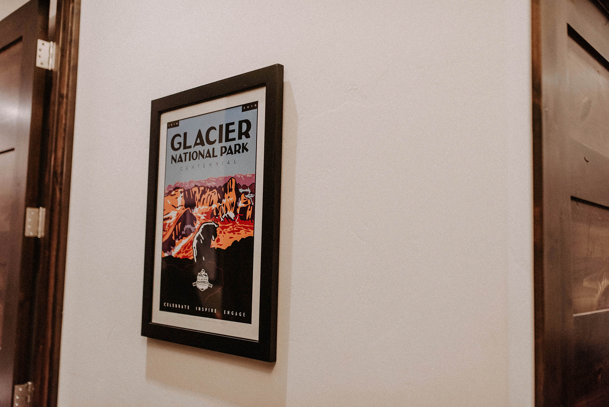 Glacier National Park poster hanging on wall