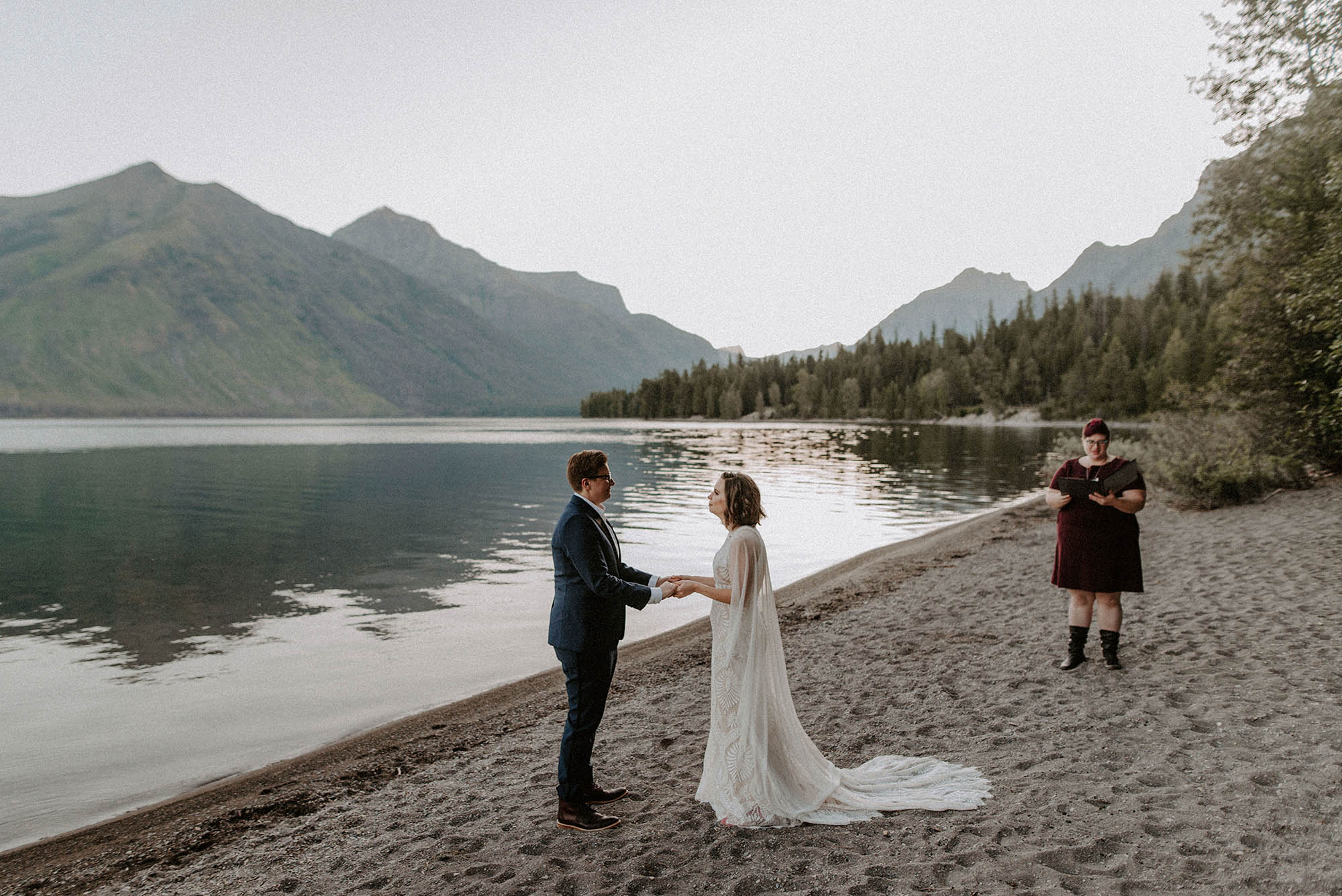 Two brides and wedding officiant at Glacier National Park elopement