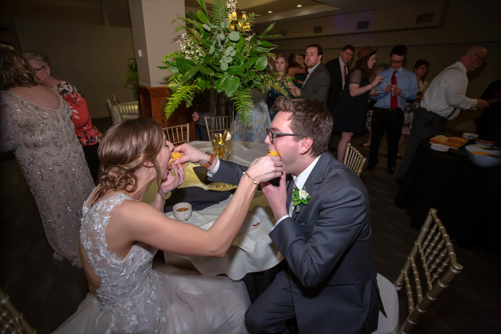 bride and groom feed each other Skyline chili dogs