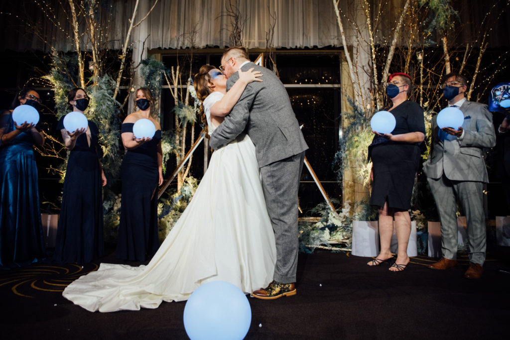 bride and groom kiss at four seasons seattle wedding ceremony