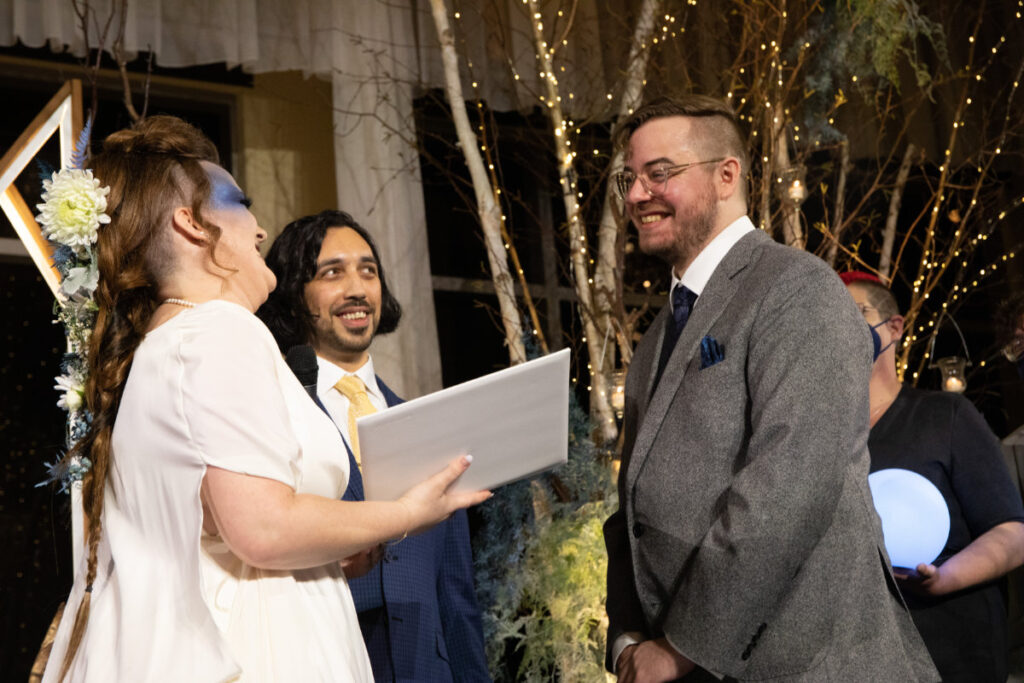 bride and groom laughing during vows at their Four Seasons Seattle wedding