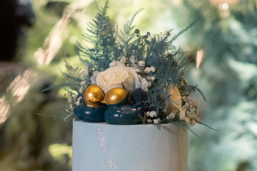 wedding cake topper with blue rubber ducks and blue flowers