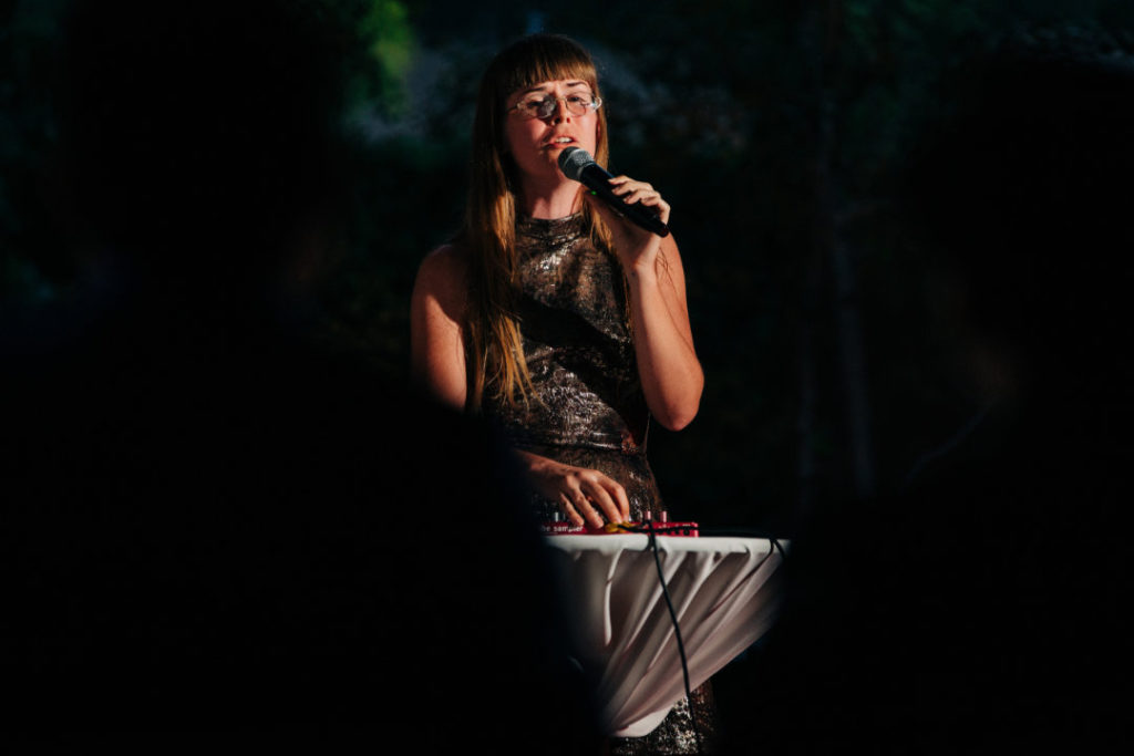 friend sings and plays instrument at wedding reception