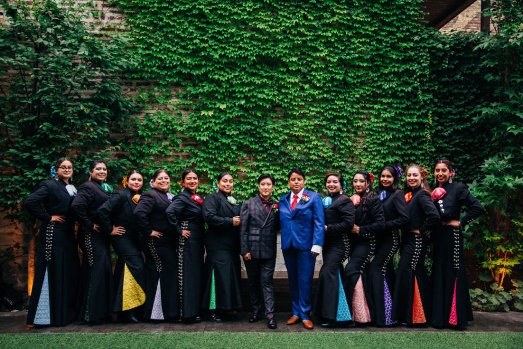 married couple with female mariachi band at wedding