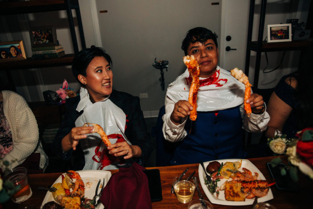 newlyweds eat seafood boil at wedding