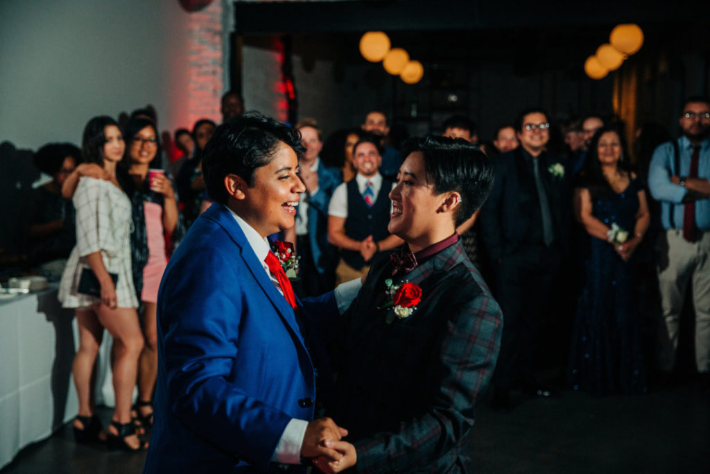 two brides in suits first dance