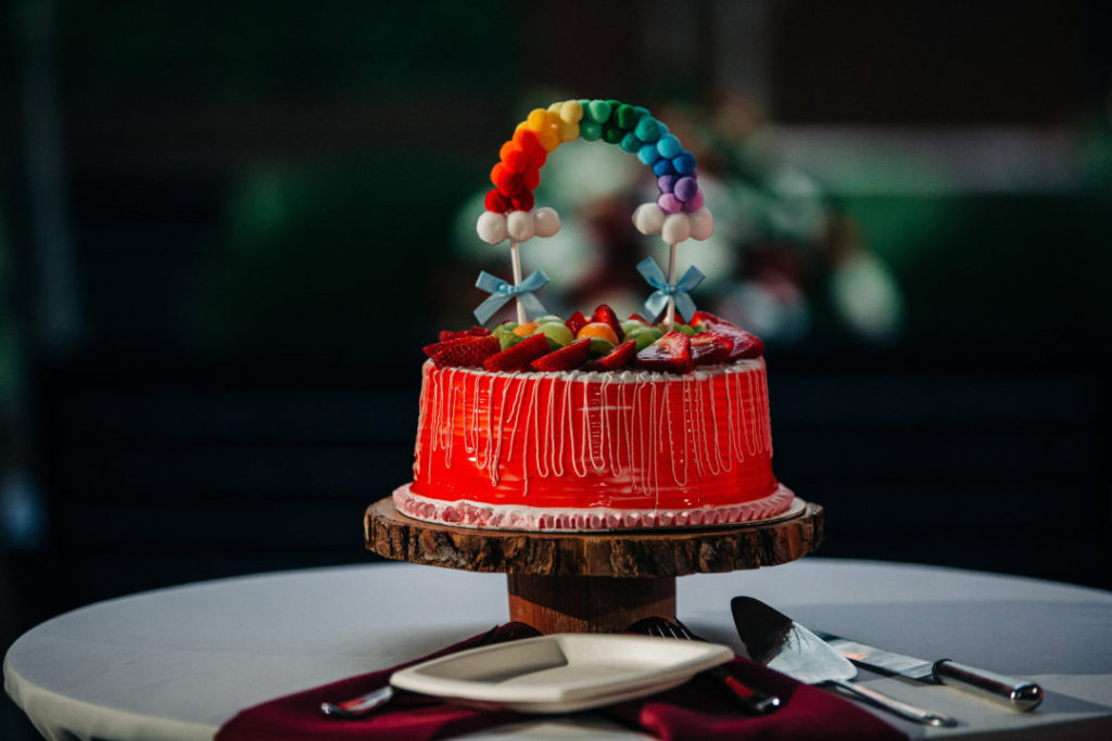 wedding cake with rainbow arch cake topper