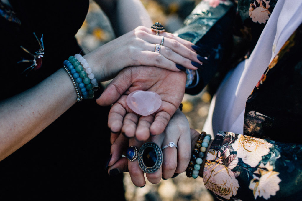 couple holding a crystal at witchy elopement