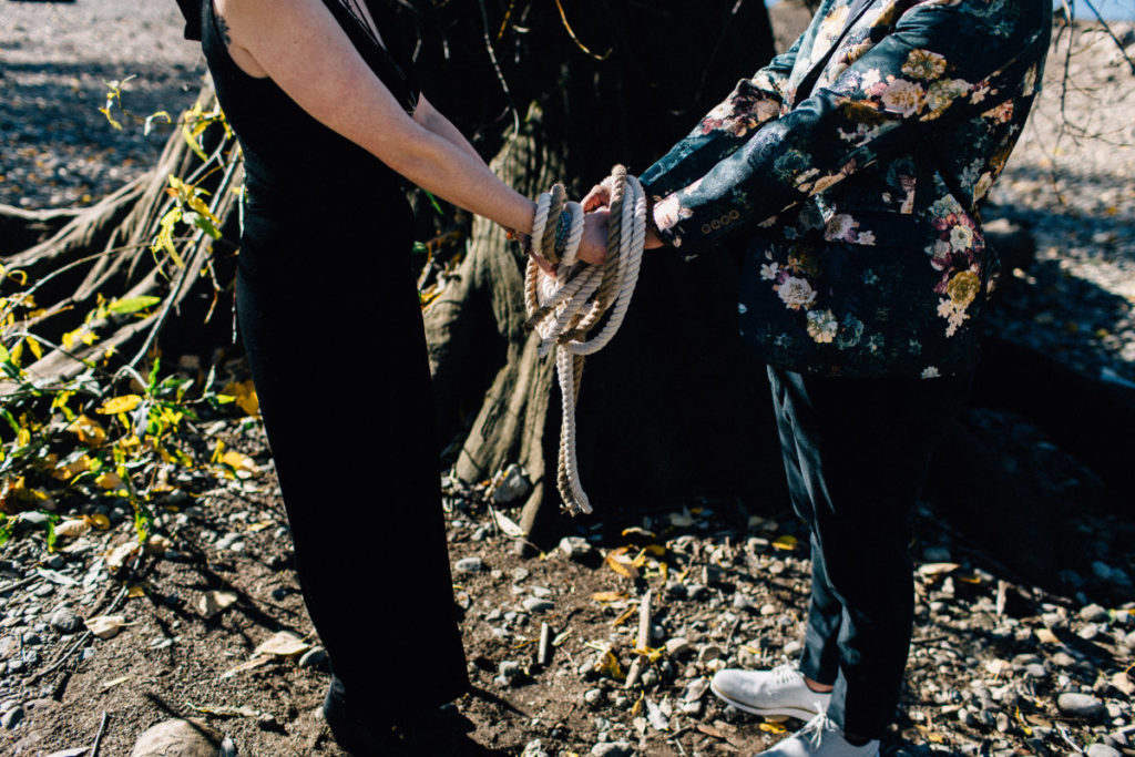 couple with handfasting cords knotted around their hands