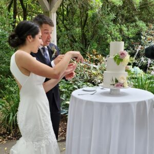 bride and groom cut cake at Wisteria Hall wedding