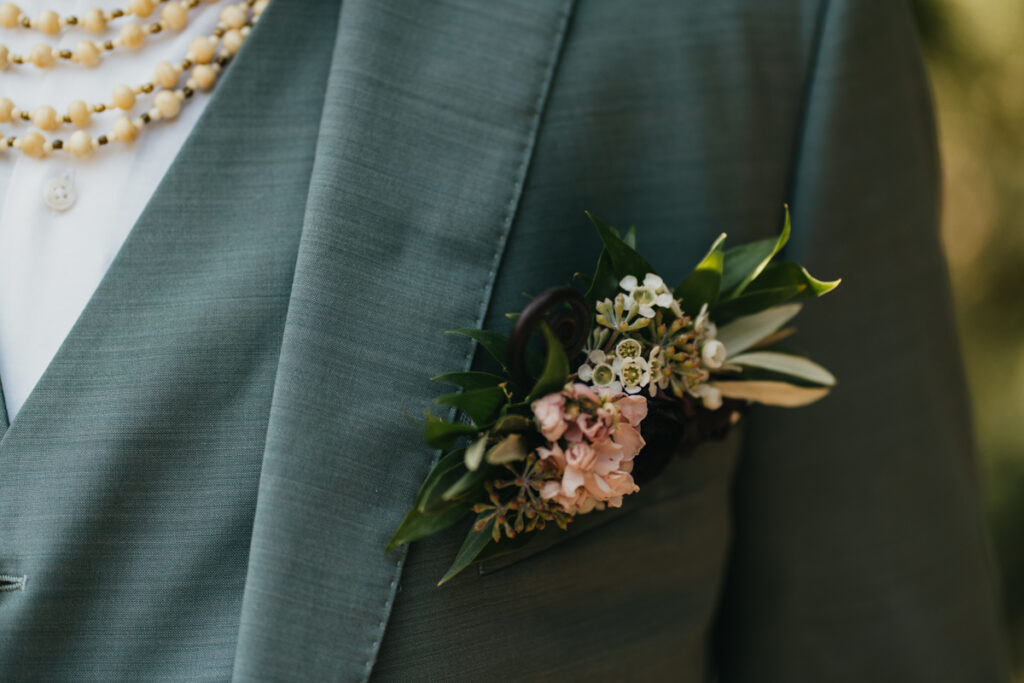 floral pocket square on a teal suit