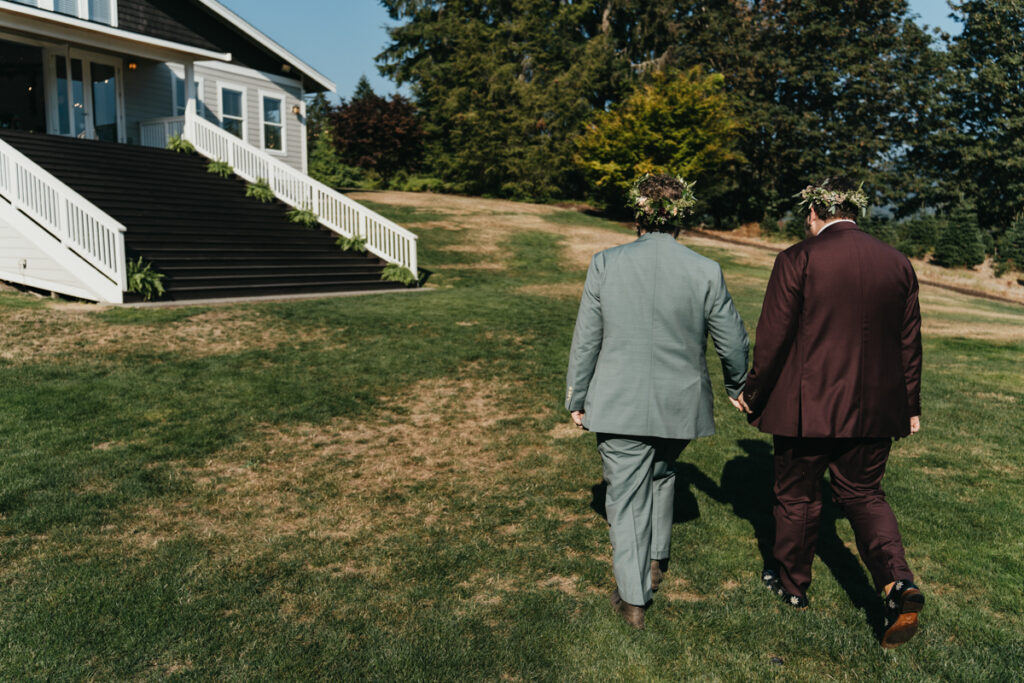 two grooms walk out of wedding ceremony at Trinity Tree Farm lodge