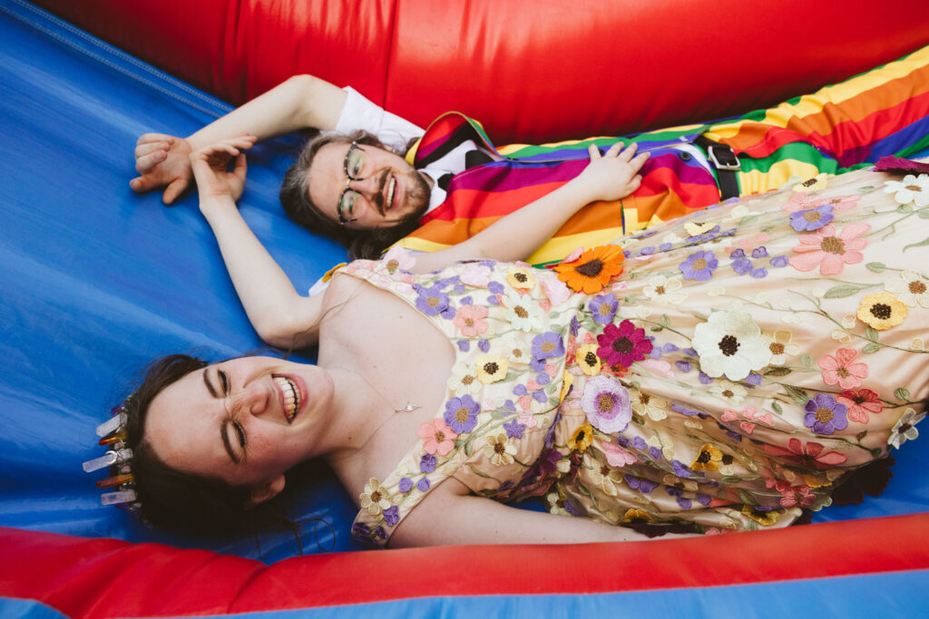 couple laying together in bounce castle