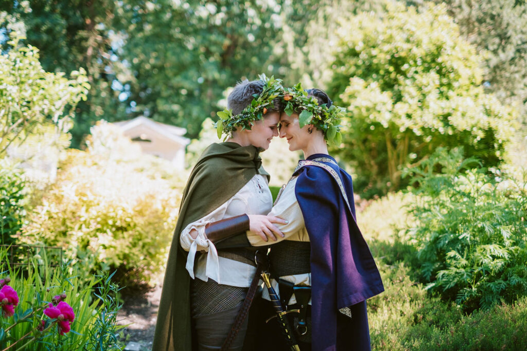 Sid and Ren standing together at forest wedding