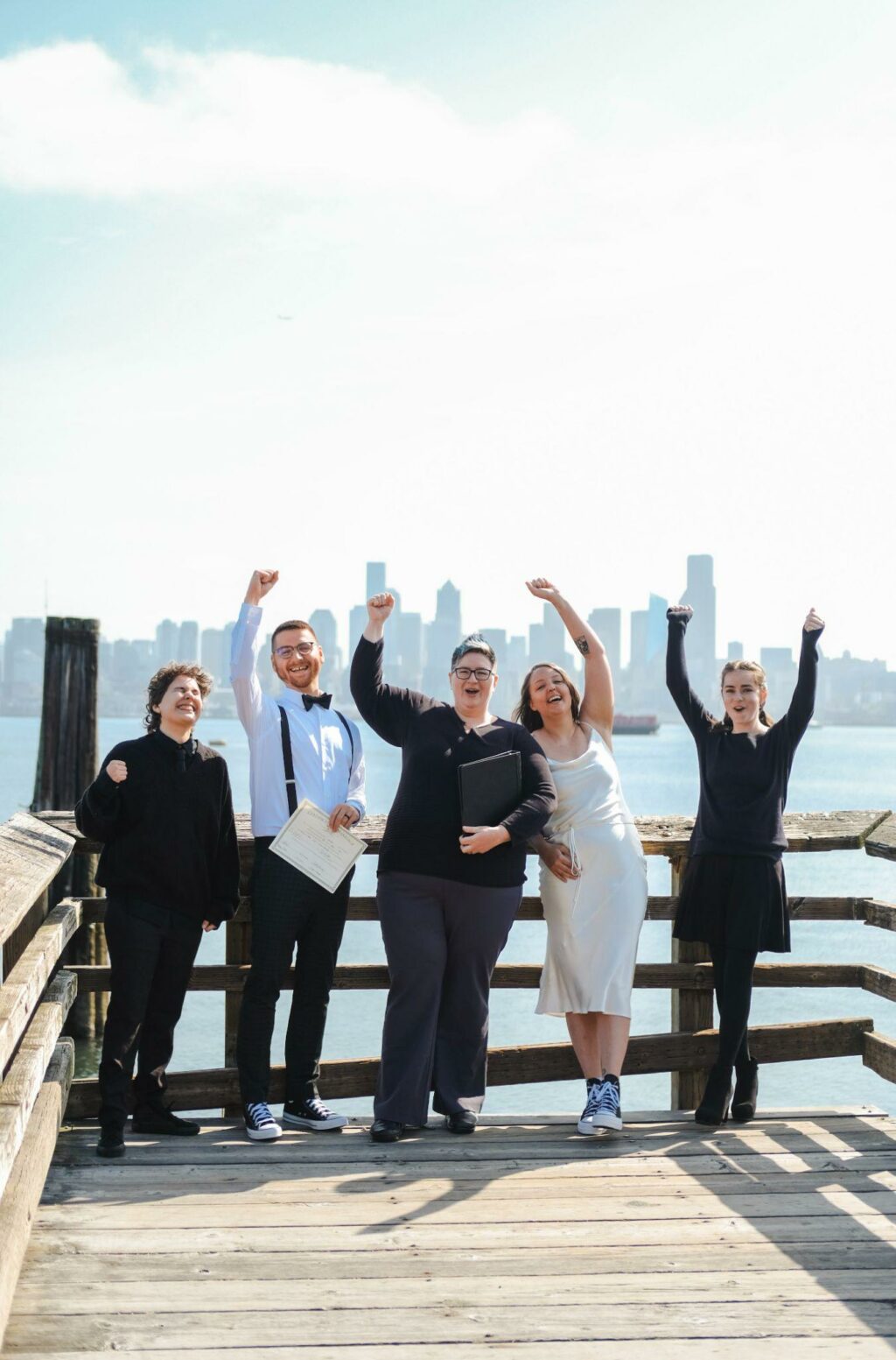 Cindy Savage cheering with wedding party on a dock in Seattle