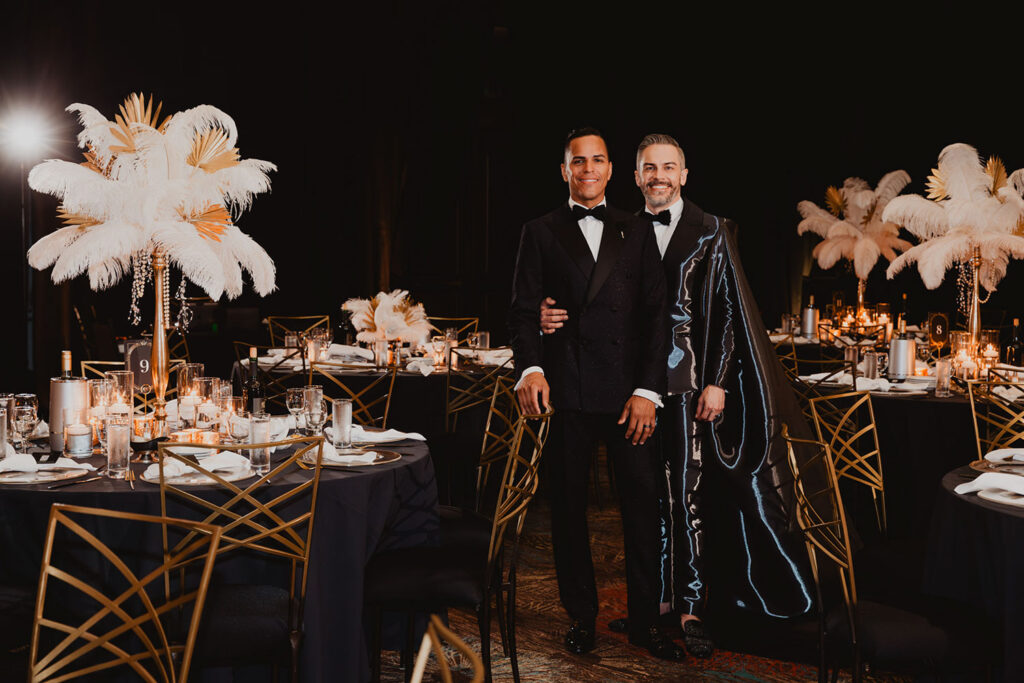 Andy and Victor standing together on their wedding day at their luxury wedding reception
