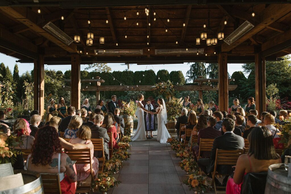 Brides exchange vows at Willows Lodge wedding ceremony.