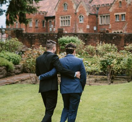 grooms walking together at wedding venue