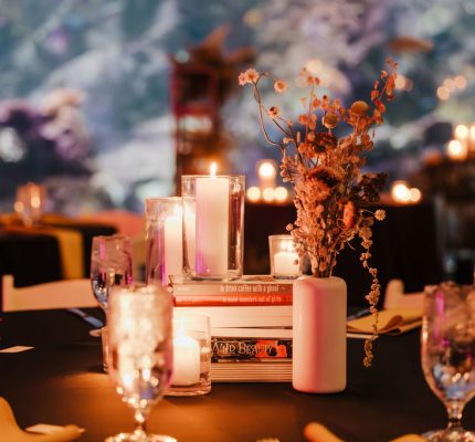 books and candles as centerpiece on wedding reception table