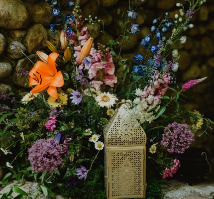 botanical wedding decor with flowers and lantern